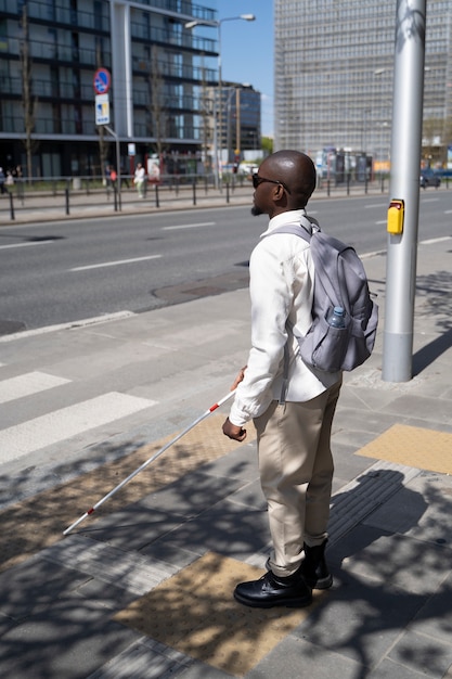 Free photo full shot blind man using street marks