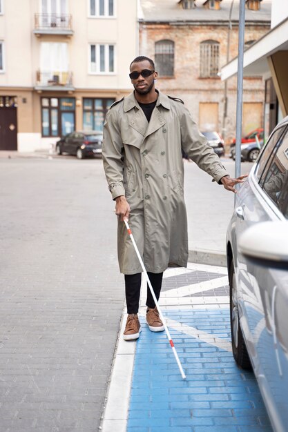 Full shot blind man with walking cane