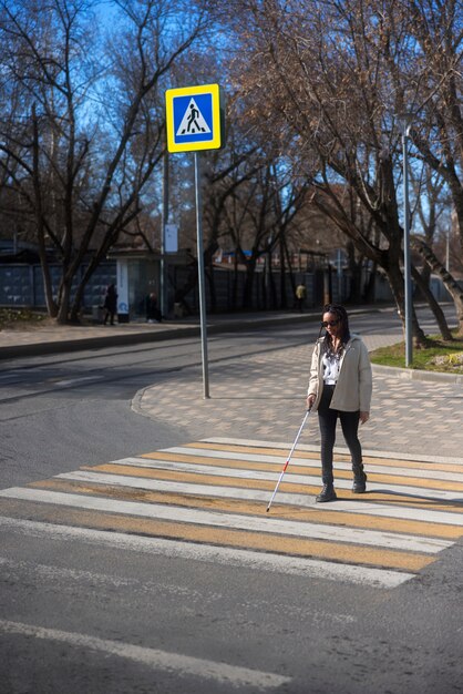 Full shot blind woman on crosswalk