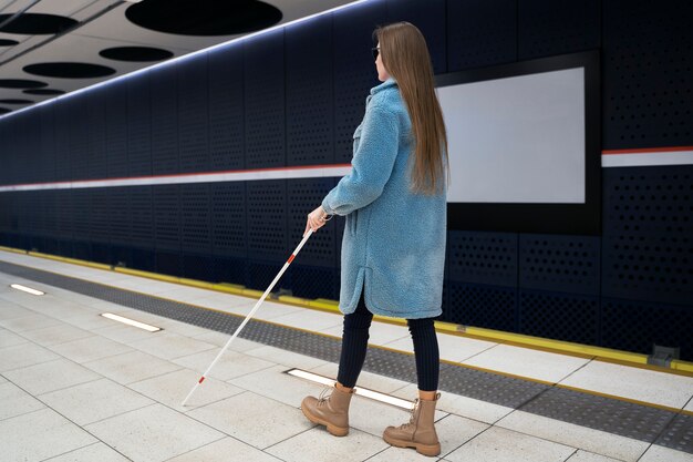 Full shot blind woman with walking cane