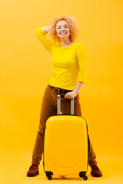 Full shot of blonde woman with suitcase