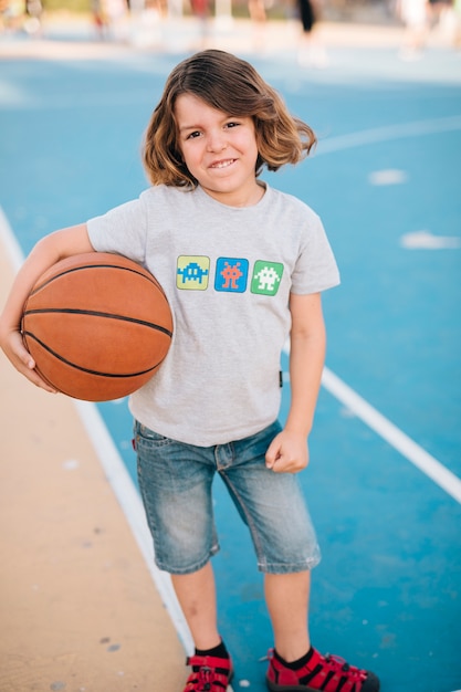 Full shot of boy holding basketball