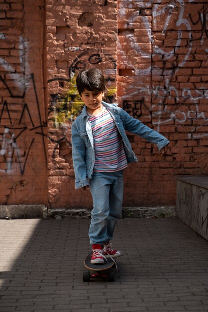 Full shot boy on skateboard outdoors