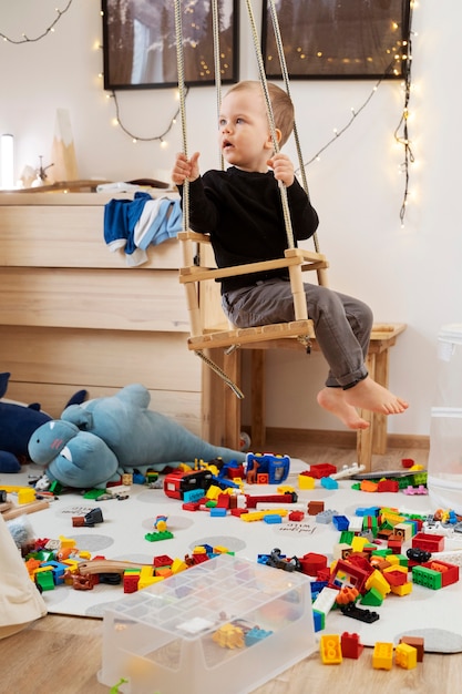 Full shot boy in swing at home