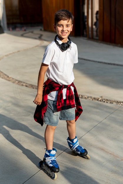 Free photo full shot of boy with blue roller blades