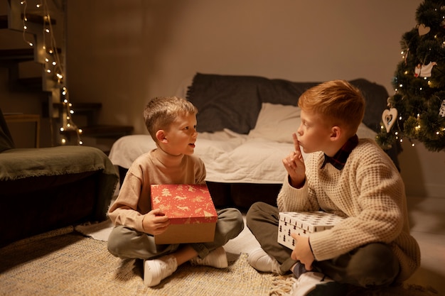 Free photo full shot boys opening gifts