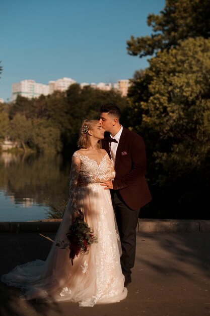 Full shot bride and groom outdoors