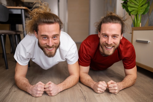 Free photo full shot brothers exercising together