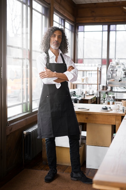 Full shot business owner with apron