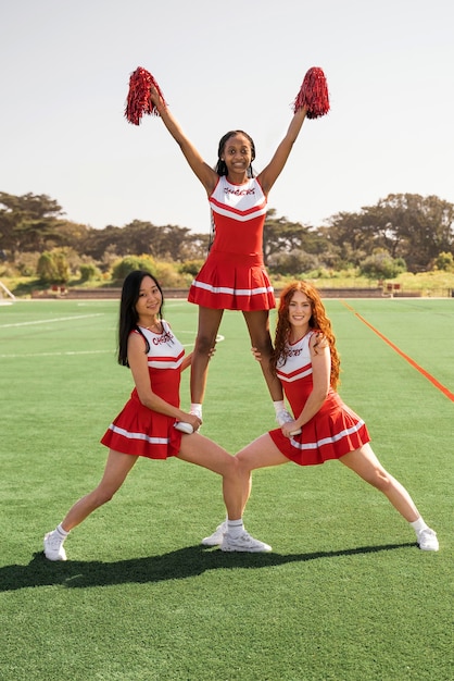 Full shot cheerleaders working out together