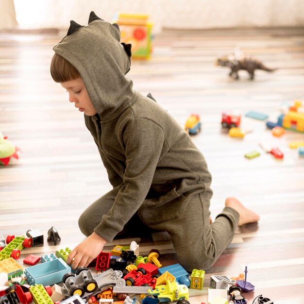 full shot child in costume playing
