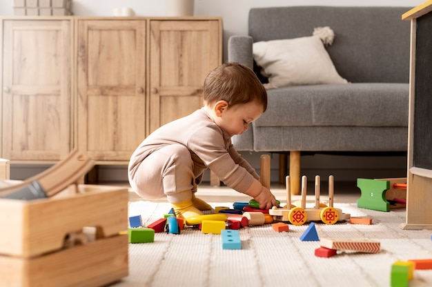 Full shot child playing with colorful toys