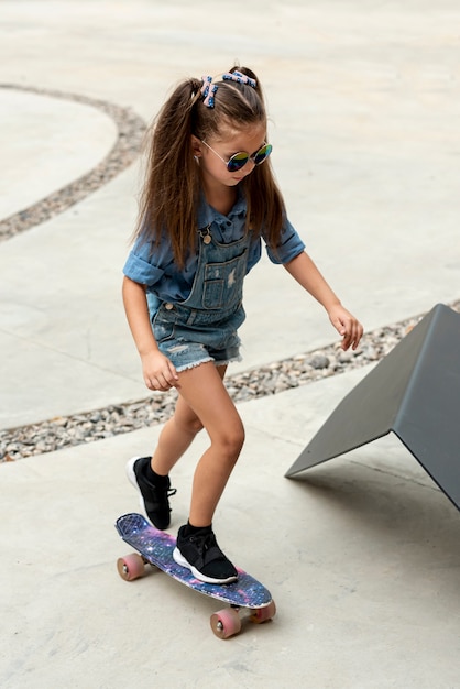 Full shot of child on skateboard