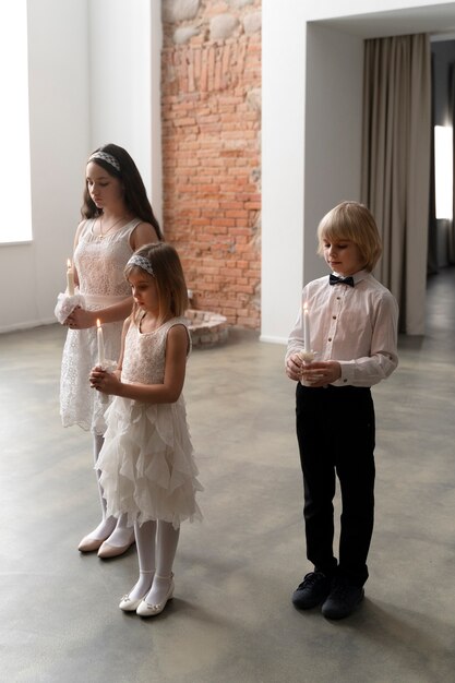 Full shot children holding candles