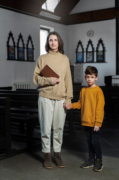 Full shot christian mother and kid at church