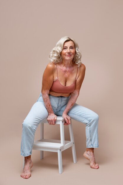 Full shot confident old woman posing in studio