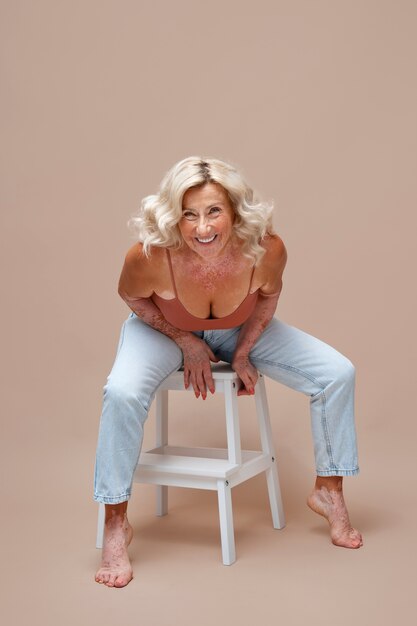 Full shot confident old woman posing in studio