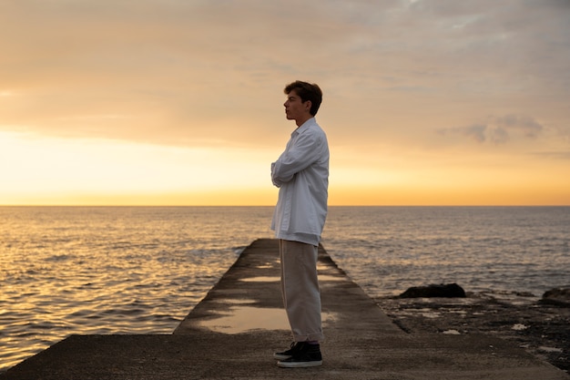 Free photo full shot contemplative man at the seaside