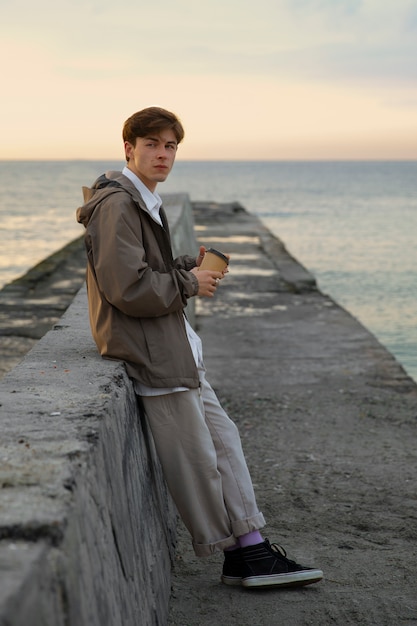 Full shot contemplative man at the seaside