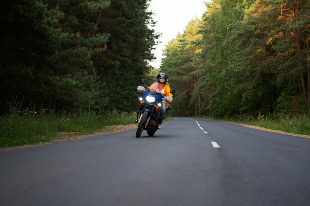 Full shot cool old woman with motorbike