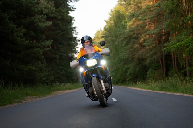 Full shot cool old woman with motorbike