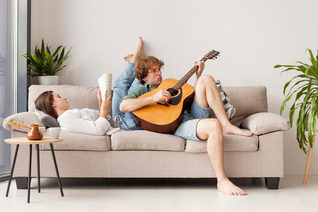 Full shot couple on the couch