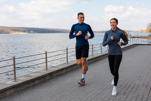 Full shot couple doing workout exercises