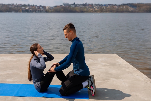 Full shot couple doing workout exercises