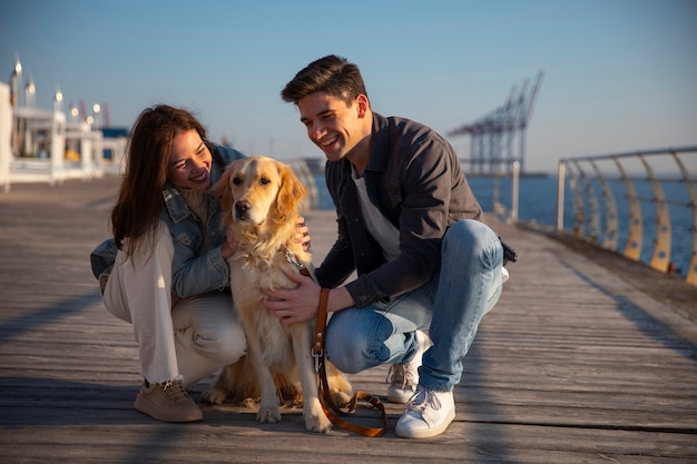 Free photo full shot couple hanging out on a jetty