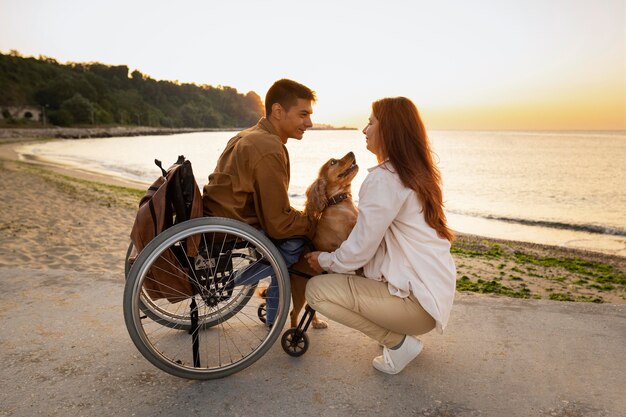 Full shot couple holding dog