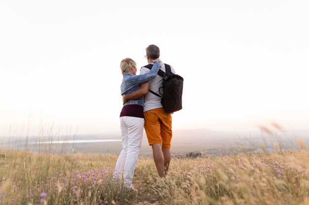 Full shot couple holding each other