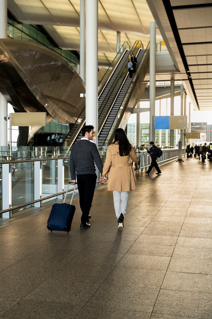 Free Photo full shot couple holding hands at airport