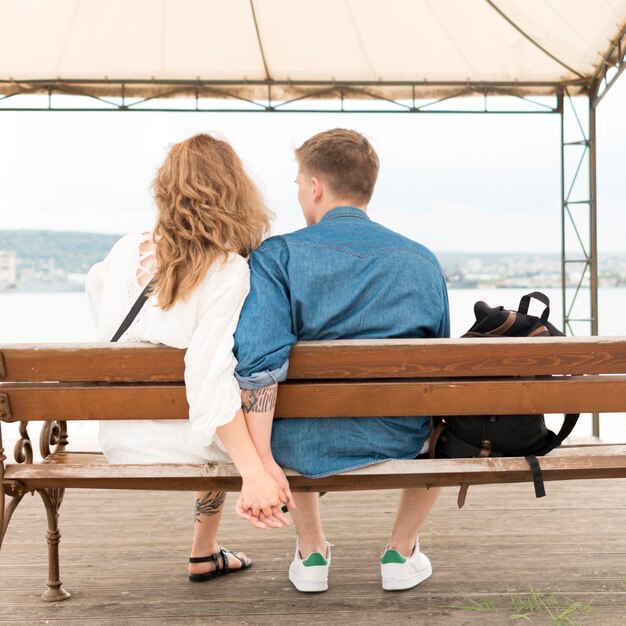 Full shot couple holding hands