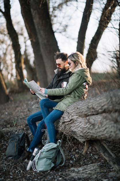 Full shot couple holding map