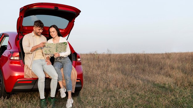 Full shot couple looking at map