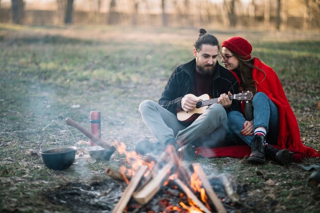 Full shot couple near campfire