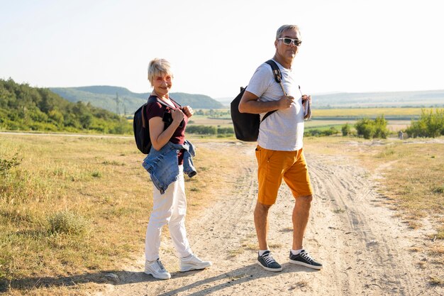 Full shot couple posing on road