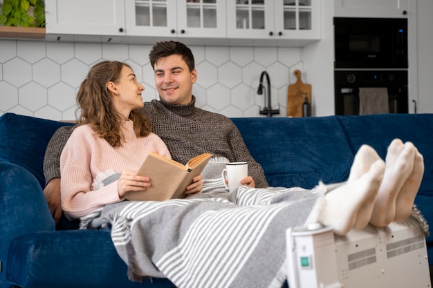 Full shot couple reading on couch