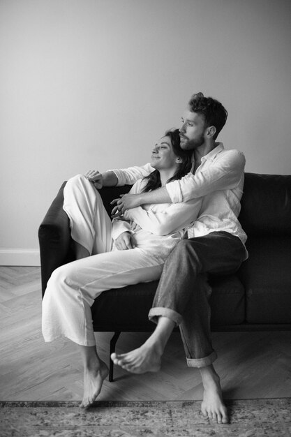 Full shot couple sitting on couch