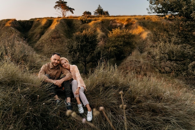 Full shot couple sitting on grass