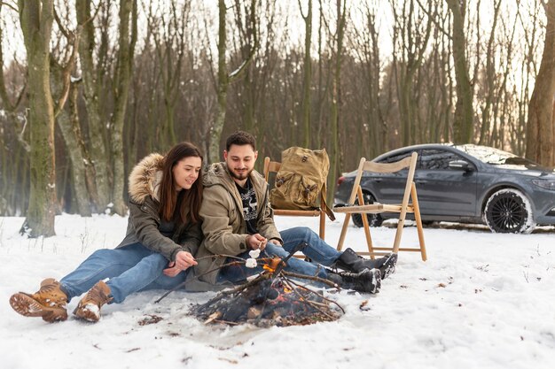 Full shot couple sitting on ground