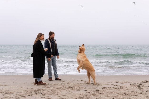 Full shot couple spending time at seaside