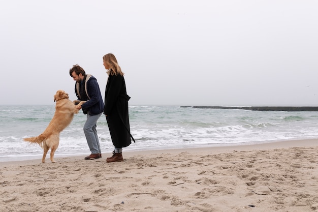 Full shot couple spending time at seaside