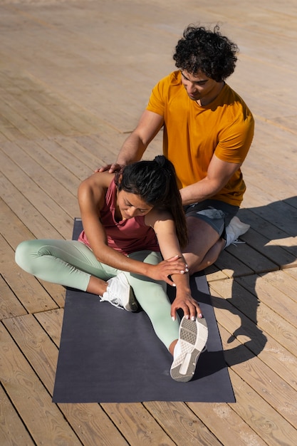 Full shot couple training outdoors