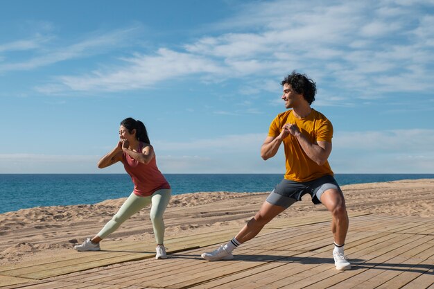 Full shot couple training outdoors