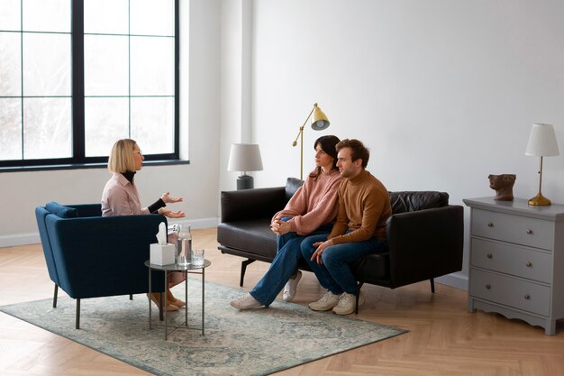 Full shot couple undergoing therapy