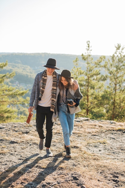 Full shot couple walking in the nature