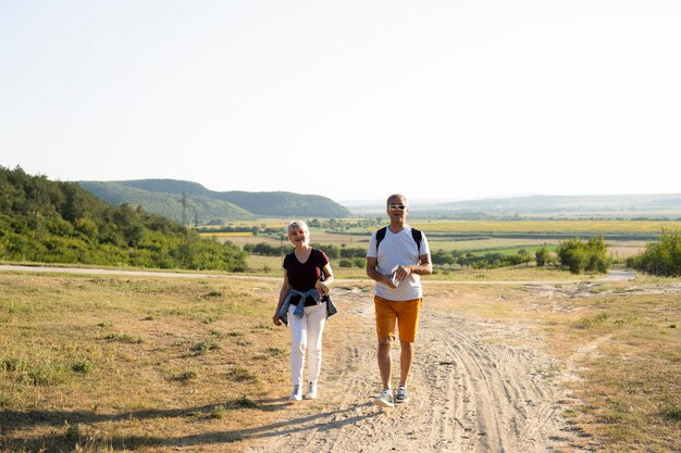 Full shot couple walking on road