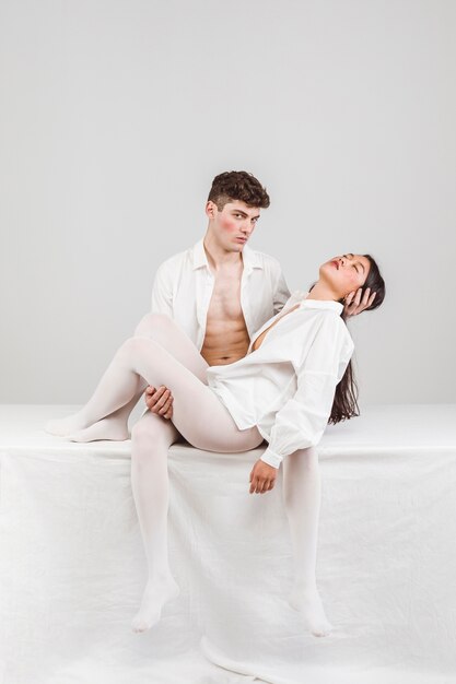 Full shot couple wearing white clothes