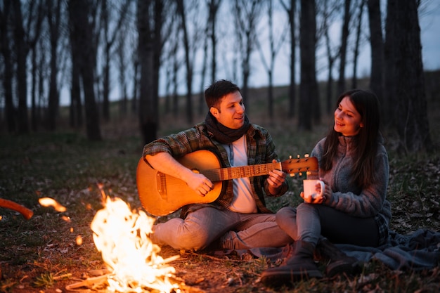 Full shot couple with guitar